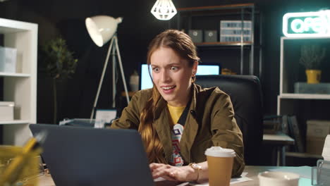excited business woman enjoying important information in dark coworking.