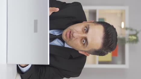 Vertical-video-of-Home-office-worker-man-confused-and-thoughtful.