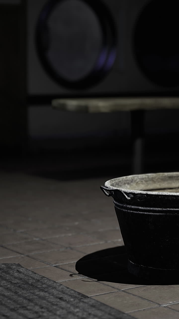 Dark corner with an empty basin at a laundromat during nighttime