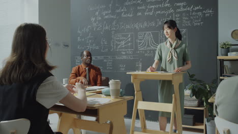 students attending a science lecture in a classroom with a professor presenting