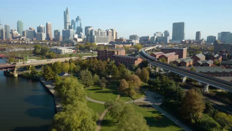 amazing aerial view of elevated subway train in chicago's chinatown neighborhood, skyline in background