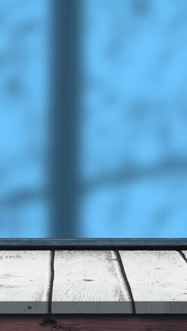 animación de hojas y sombras de ventanas sobre fondo azul y de madera