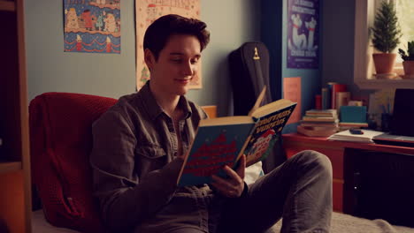 young man reading a book in his cozy bedroom