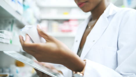 a young female pharmacist using her tablet