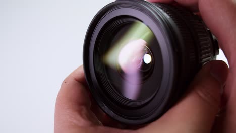 close-up of a camera technician checking and adjusting the lens