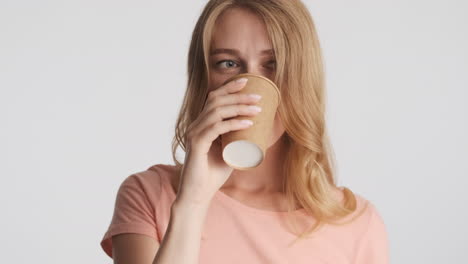 caucasian woman drinking water on camera.