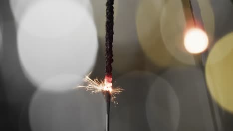 Video-of-close-up-of-sparkler-with-bokeh-and-copy-space-on-black-background