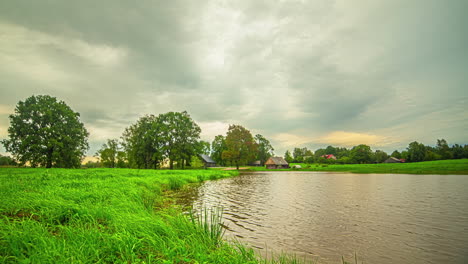 From-glowing-sunrise-to-rainy-weather-near-rural-homestead,-time-lapse-view