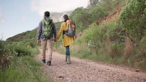 backpack, couple holding hands and hiking outdoor