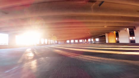 cinematic video of a car driving in a parking garage at sunset with sun peaking in chicago 4k