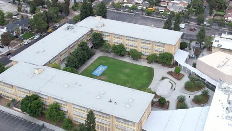 crenshaw public secondary high school aerial view pull away above rooftop los angeles california