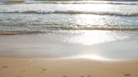 Sparking-Baltic-sea-wawes-hitting-sandy-beach-coastline,-sunny-day