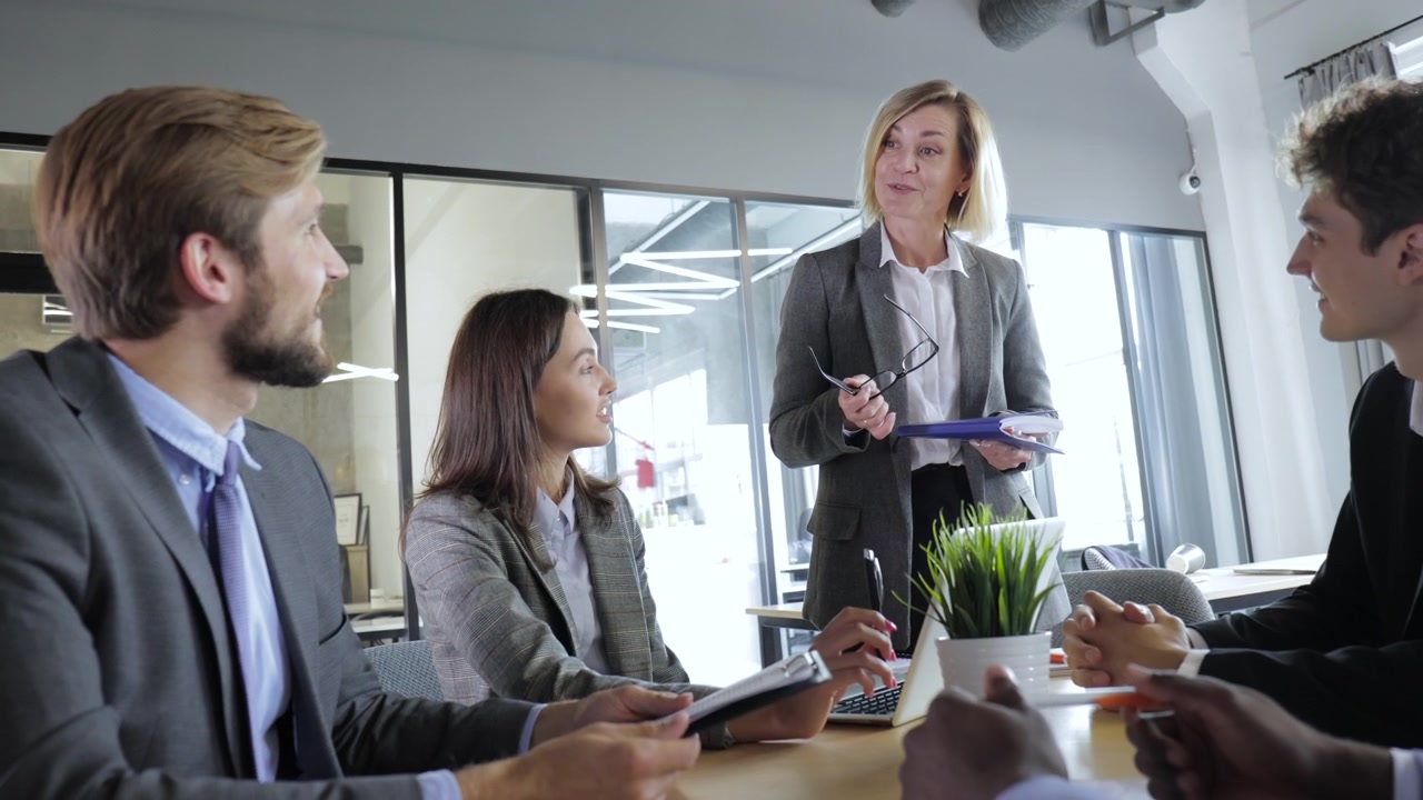 Female Manager Leading a Business Meeting with Diverse Team in Modern Office