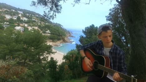 Young-boy-playing-acoustic-guitar.-Teenage-guitarist-with-musical-instrument