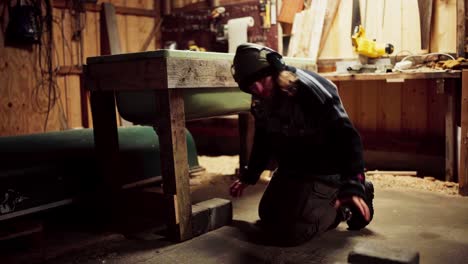 a man is placing bricks beneath the framework support of a diy hot tub - static shot