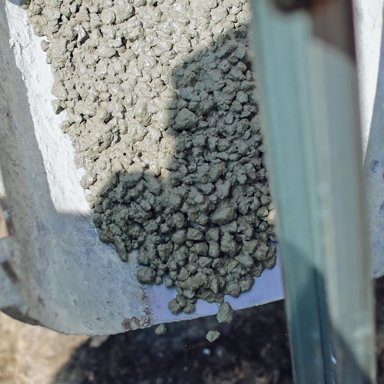 Metal basis for solar panel on the construction site. Ready cement is pouring out to fix metal frame. Close-up.