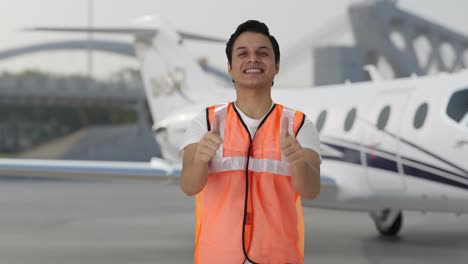 Happy-Indian-airport-ground-staff-showing-thumbs-up