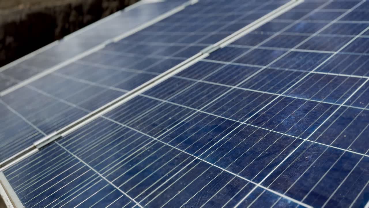 Close-up view of solar panel made up of multiple rows of blue photovoltaic cells