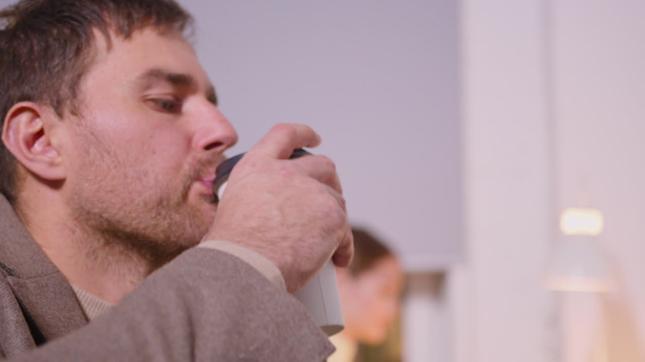Close Up Of A Businessman Drinking Takeaway Coffee While Working In A Coworking Space