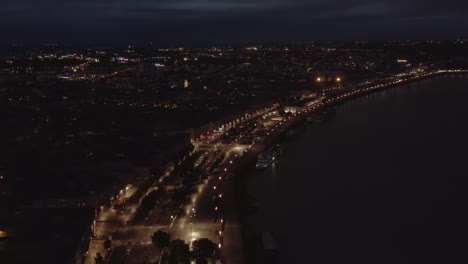 Bordeaux-Riverside-of-Garonne-River-wide-view-at-Night,-Aerial-forward