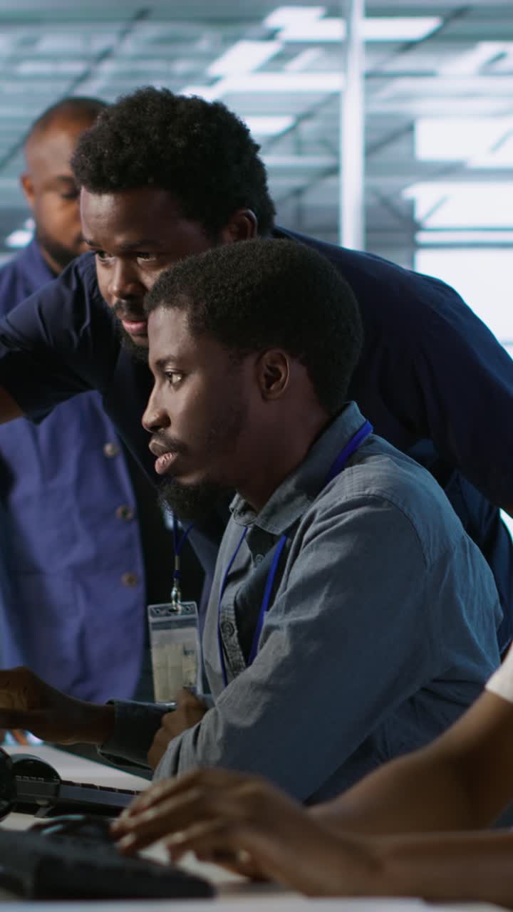 Vertical video Manager supervising server room workers