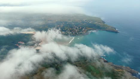 cantabria coastline, scenic ajo bay, aerial view above clouds, spain