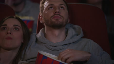 close up view of young people faces watching movie