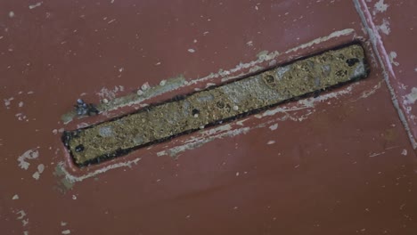 zinc anode flush with ship hull appears worn and dirty during inspection in drydock. anti corrosion use.