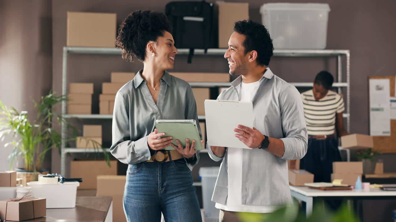 Happy Business Partners Working Together in a Small Warehouse