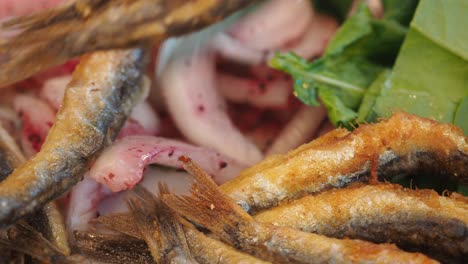 close-up of crispy fried fish with garnishes