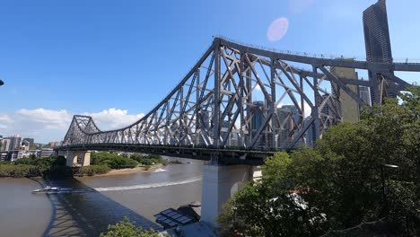 angled perspective of brisbane's story bridge with moderate traffic and citycat