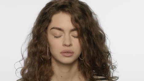 Tired-woman-headache.-Portrait-of-upset-girl-touching-head-with-hand-in-studio