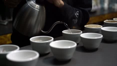 specialty coffee professionals coffee cupping session - preparing for cupping to taste the coffee quality