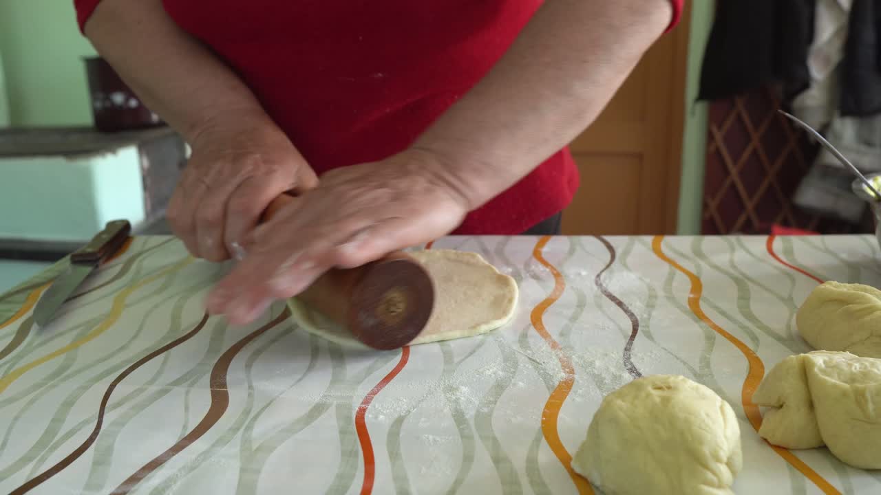 Woman Stretch Dough For Pies Through Flour With Rolling Pin