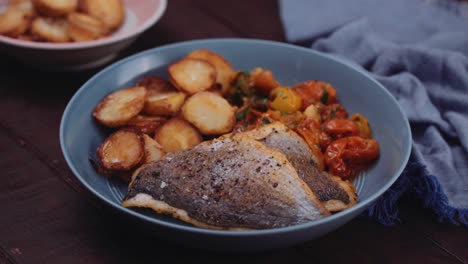 Delicious-fish,-potatoes-and-tomatoes-for-a-healthy-snack--close-up-pan
