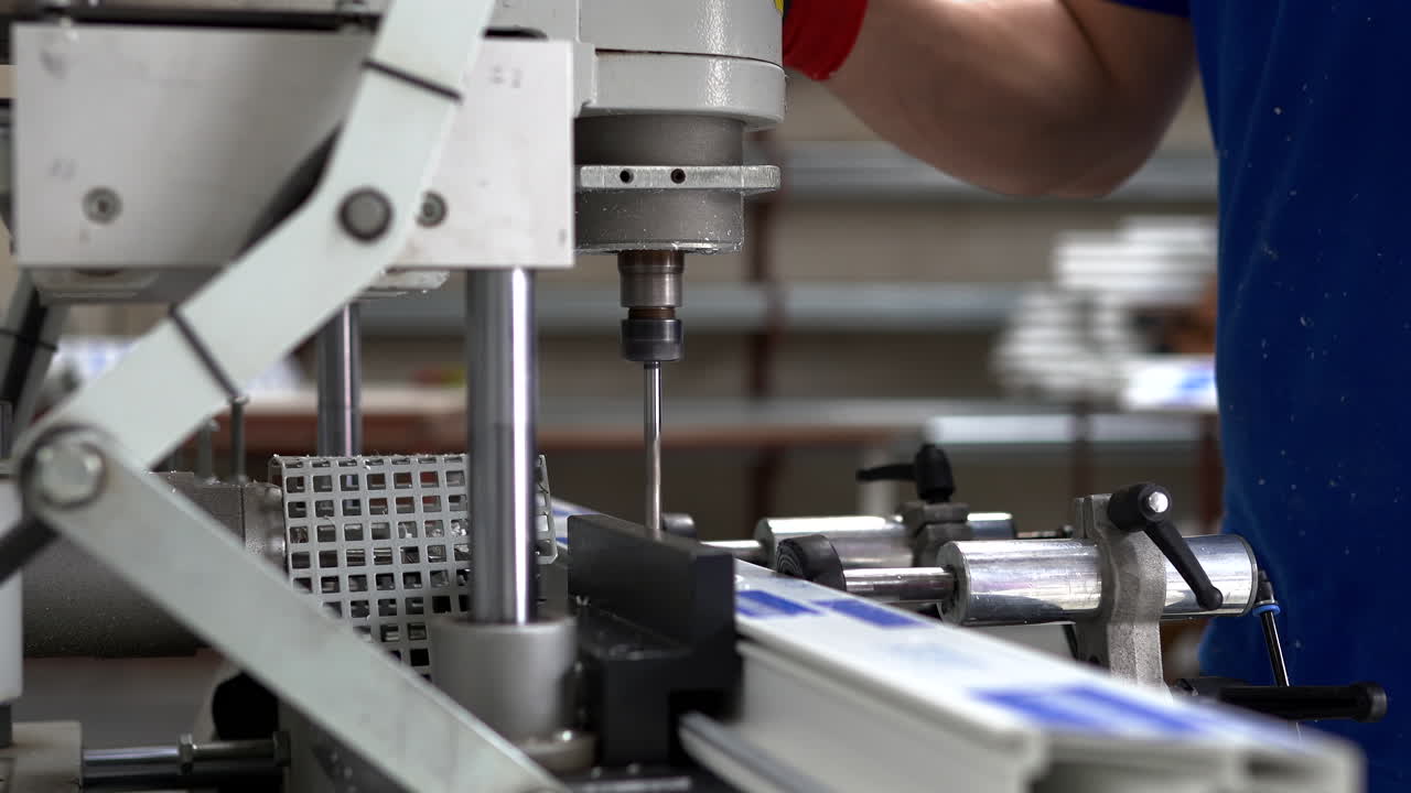 Factory Workers Operating PVC Frame Manufacturing Equipment