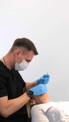 a person wearing protective gear administers an injection to someone, signaling safety and care through their gestures.