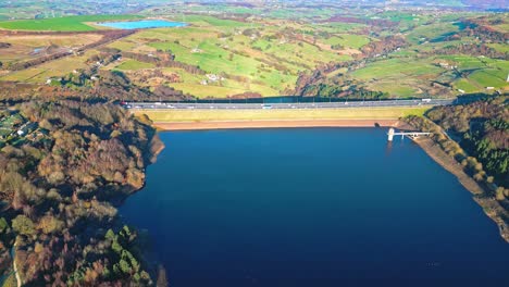 winter aerial footage scene of scammonden reservoir with the m62 motorway bridge