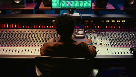 sound designer relaxing on studio chair after mixing and mastering tracks