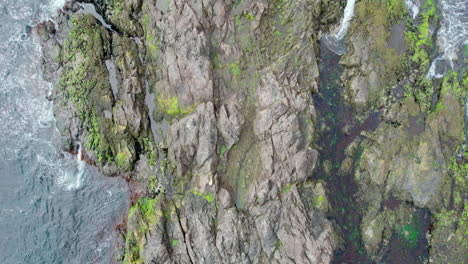 Top-down-view-of-a-rock-in-the-white-foamy-waters-of-Narragansett-Bay,-Rhode-Island