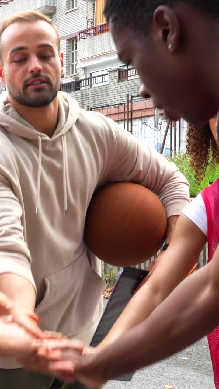 Basketball team huddling together