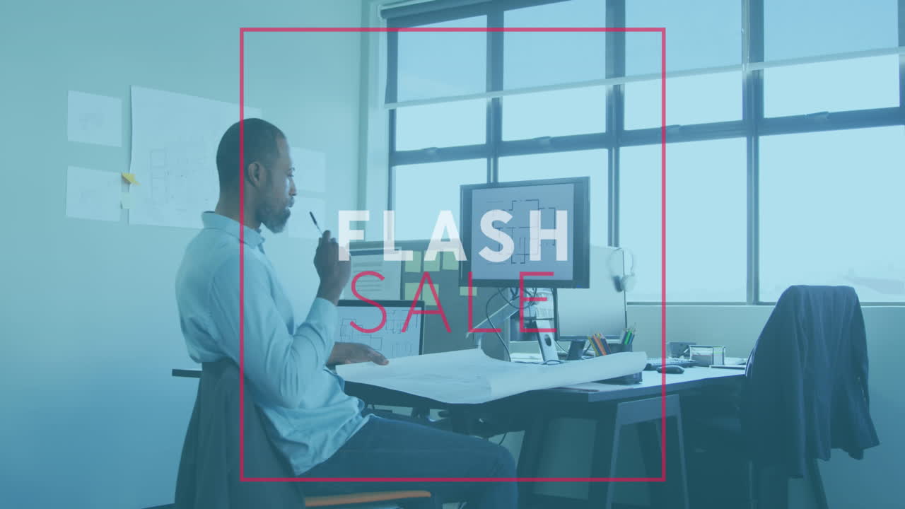 Animation of flash sale text banner over thoughtful frican american man working on a plan at office