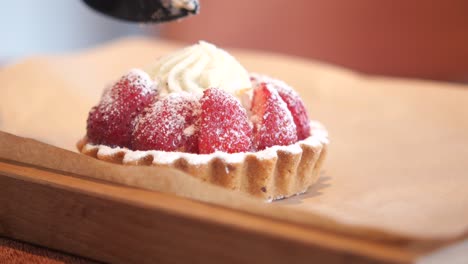 strawberry tart on a wooden tray