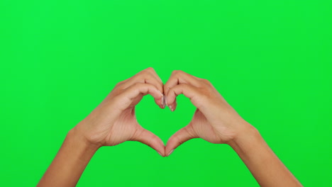 Heart,-shape-and-hands-of-a-person-on-green-screen