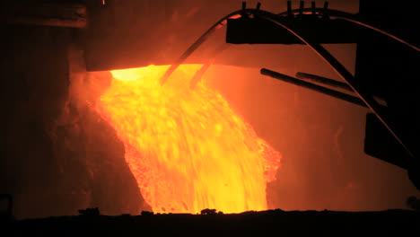 molten metal pouring out of furnace. liquid metal from blast furnace