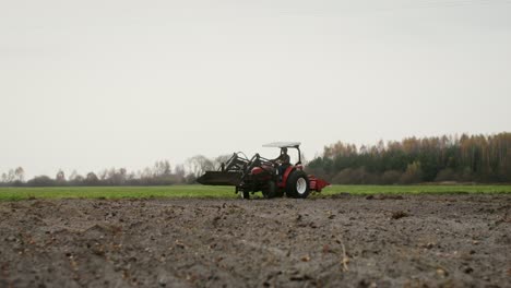 farmer working in a field with a tractor