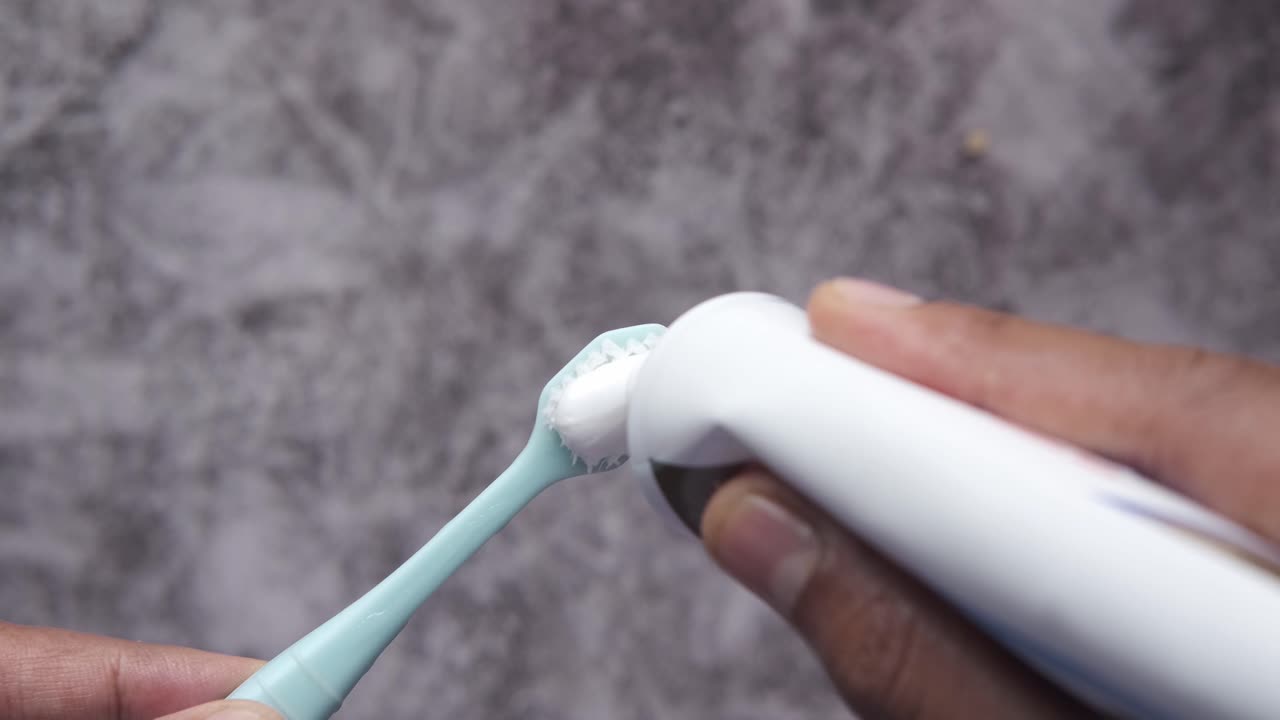 Applying Toothpaste to a Toothbrush
