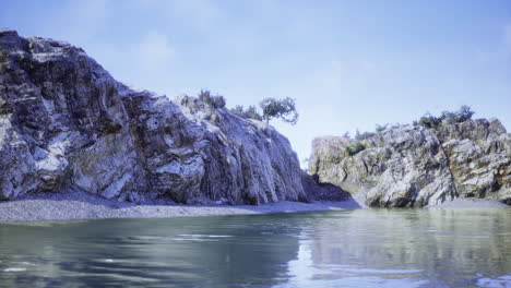 natural landscape featuring rocky cliffs and calm water under blue sky