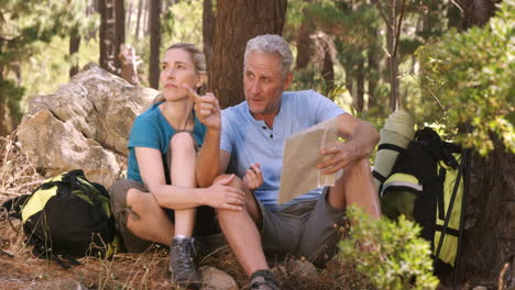 Couple-using-map-and-compass-to-find-the-way