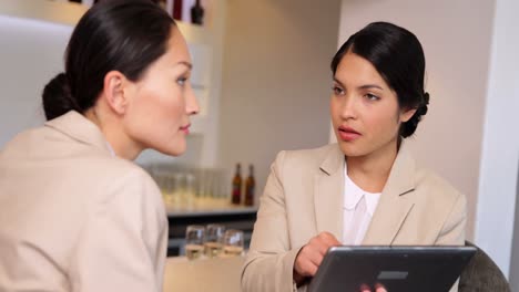 Businesswomen-looking-at-tablet